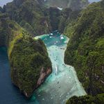 Explore the breathtaking aerial vista of Krabi, Thailand, showcasing vibrant turquoise waters and rugged limestone formations.