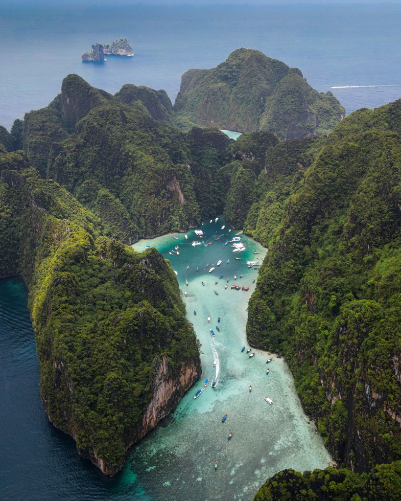 Explore the breathtaking aerial vista of Krabi, Thailand, showcasing vibrant turquoise waters and rugged limestone formations.