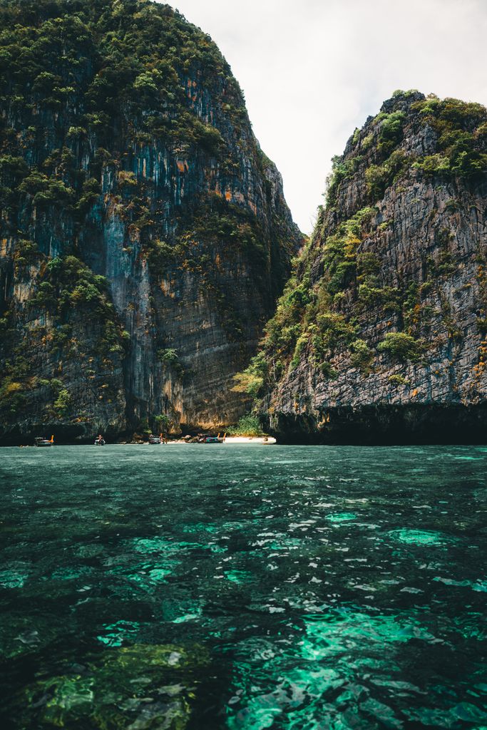 Explore the breathtaking limestone cliffs and turquoise waters of Viking cave phi phi island, Thailand.