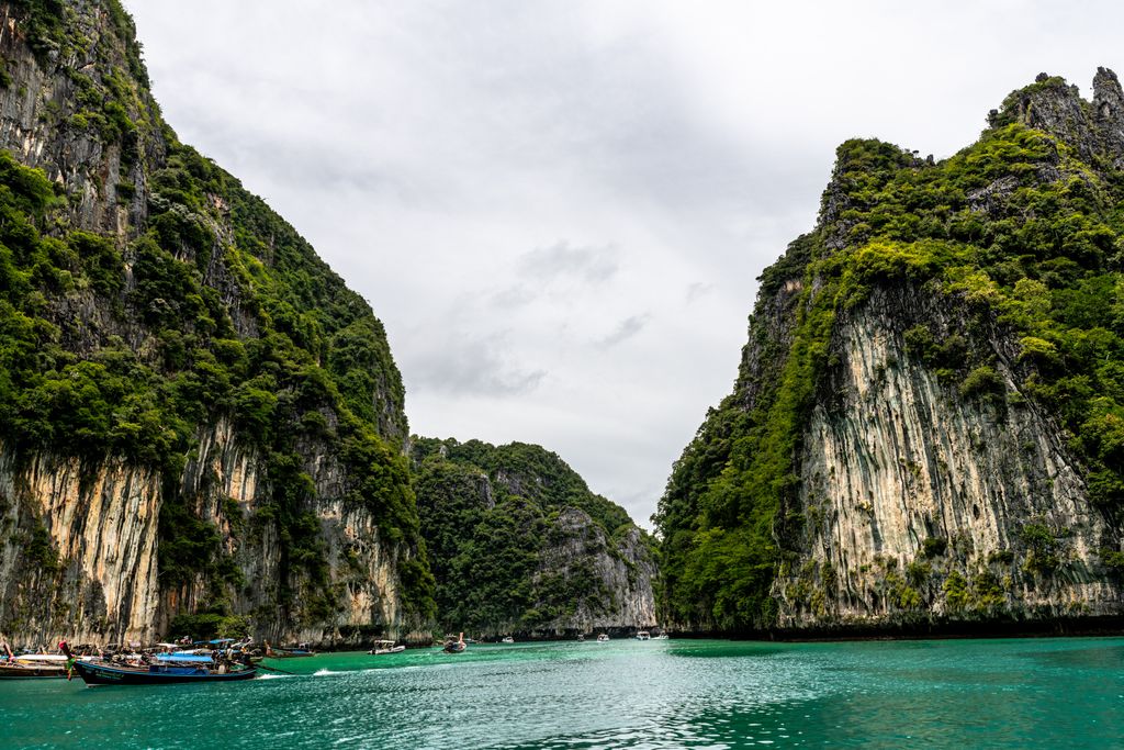 Stunning view of emerald waters surrounded by cliffs in Pileh Lagoon Phi Phi Island, Thailand.