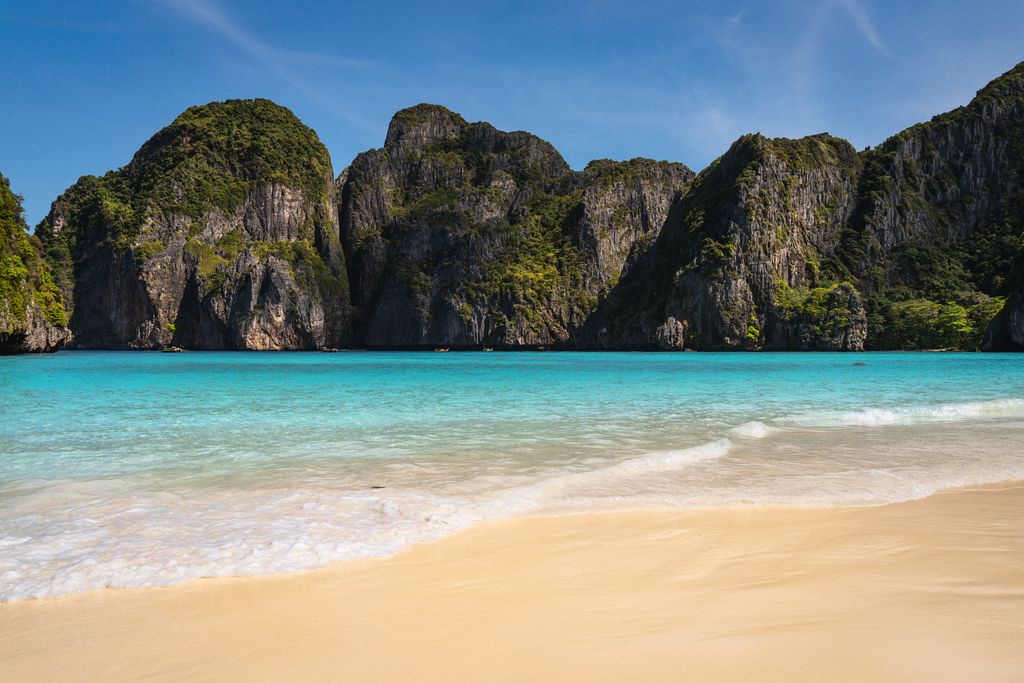 Stunning view of Maya Bay's turquoise waters and limestone cliffs in Krabi, Thailand.
